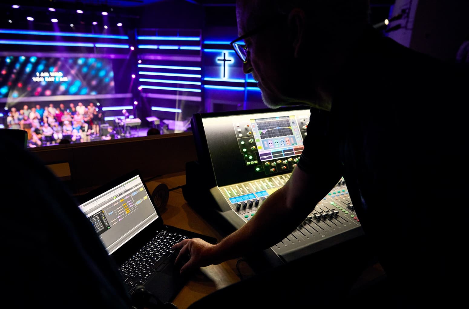 Audio design expert uses sound design system management software during church.